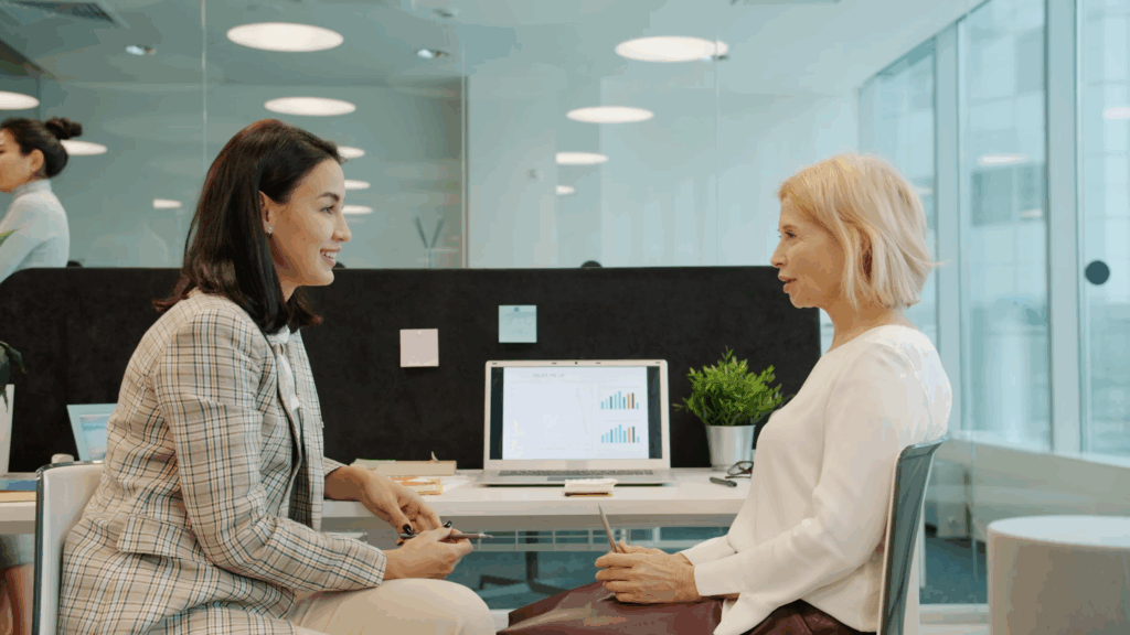 two women talking in a modern office