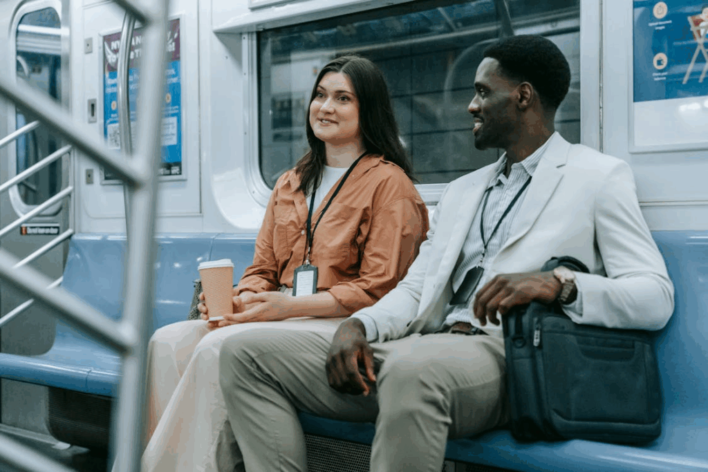 A Man and Woman Sitting Inside the Train while Having Conversation
