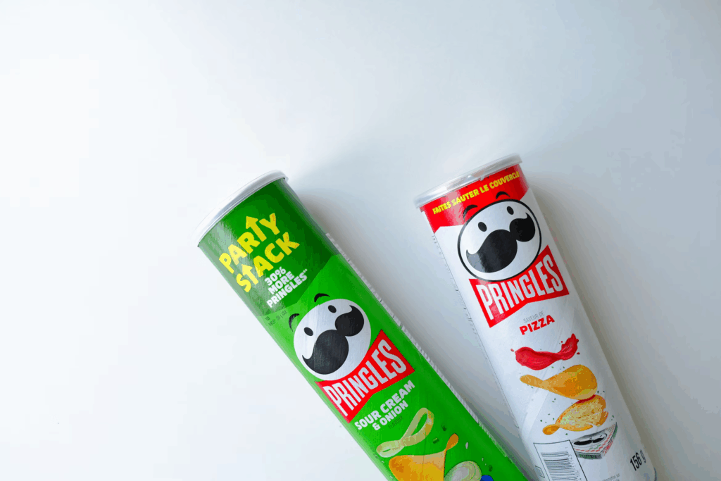 two tubes of Pringle's chips in green and white