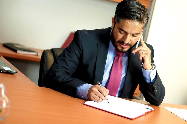 Man talking on phone at desk