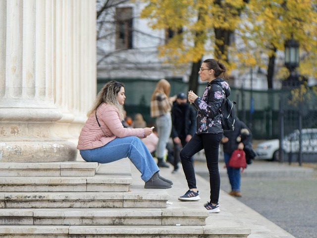 two women talking on a flight of stairs