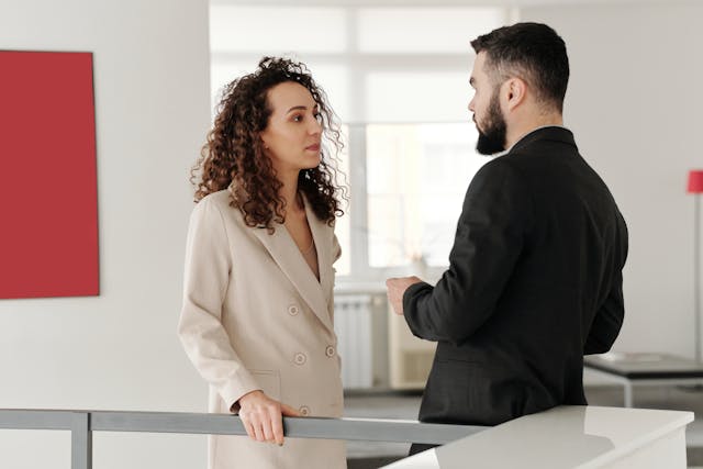 man and woman talking in an office