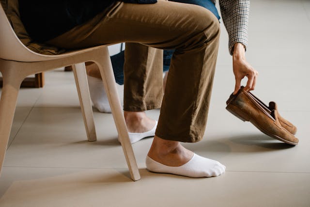 person putting on shoes