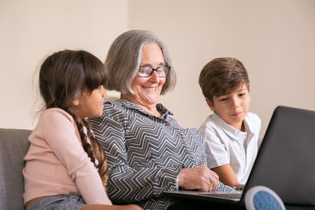 grandmother sitting with grandchildren
