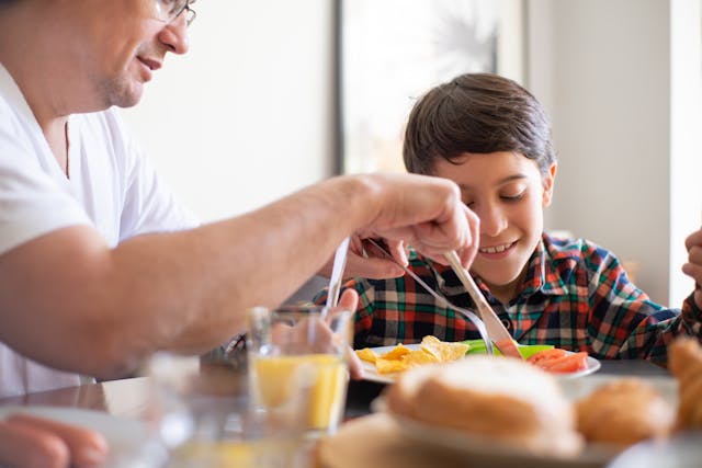 father and son eating 