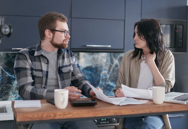man and woman talking in an office
