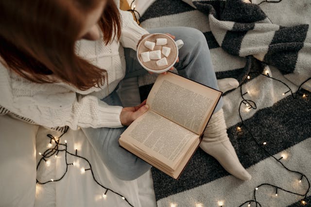woman on bed reading book