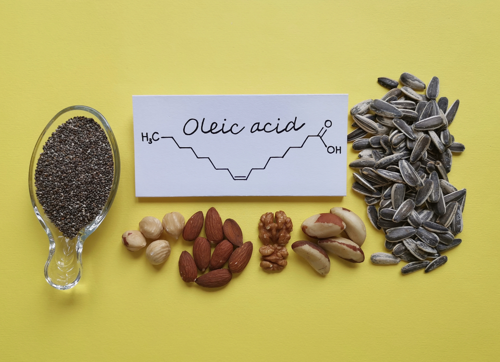Structural chemical formula of oleic acid, an omega-9 fatty acid, with natural sources of oleic acid. Foods rich in oleic acid: sunflower seed, chia seed, Brazil nut, walnut, hazelnut, and almond.