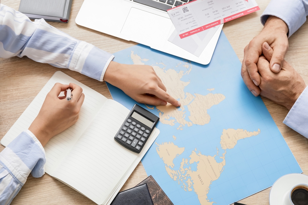 Travel agent choosing tour for client in office