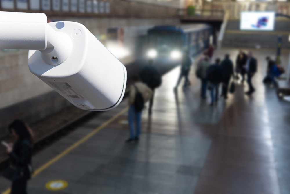 CCTV, security camera system operating with people waiting subway at train station, surveillance security and safety technology concept