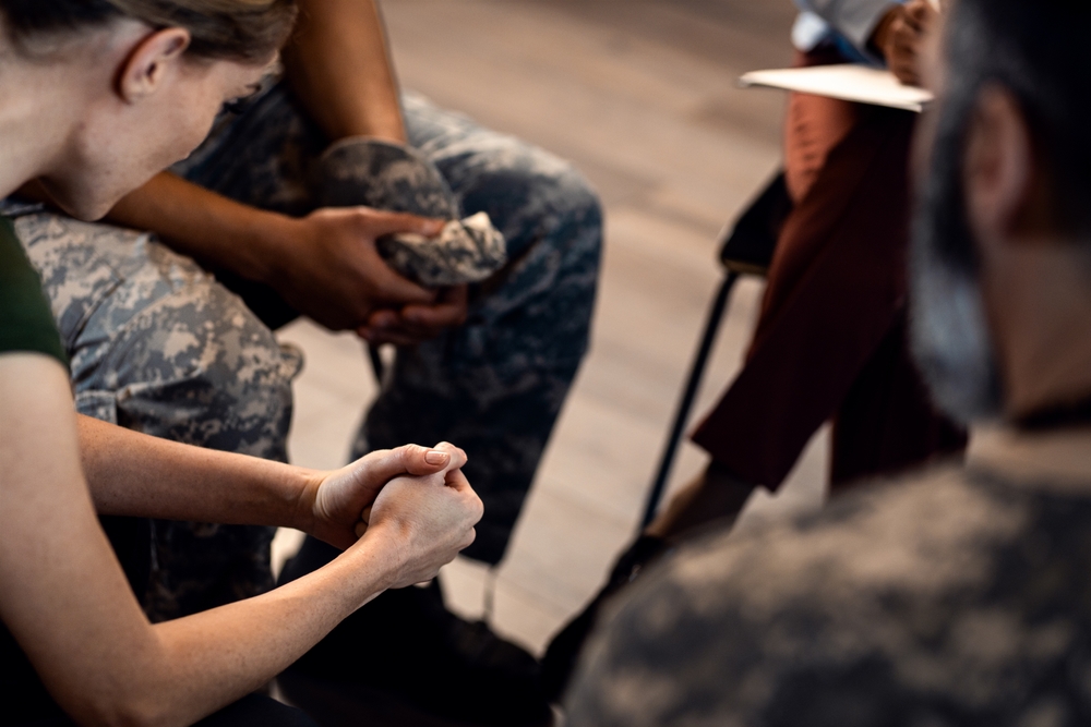 Close up of female veterans hans during PTSD support group.