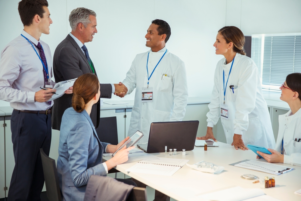 Scientists and business people talking in conference room