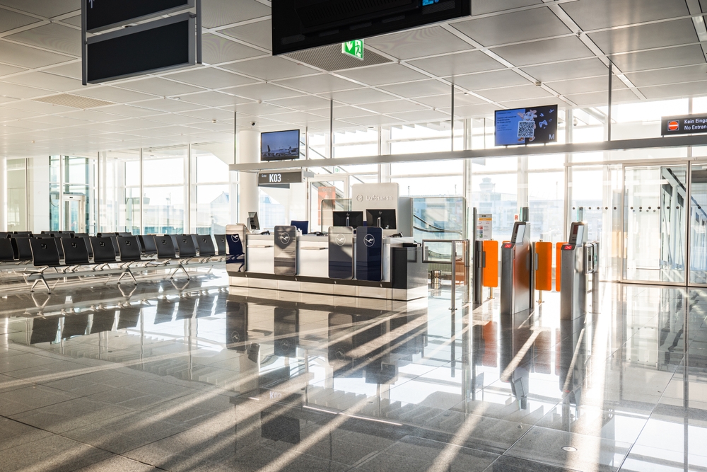 07.03.2025 , Munich International Airport, Germany.  Empty departure boarding gate K03. Late evening sunlight, backlit, wide angle, no people.