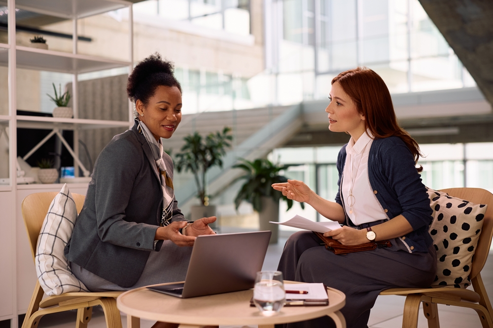 African American financial advisor using laptop during a meeting with her client in the office. 