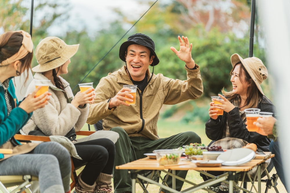 A popular Asian man drinks beer and tells jokes with his friends at fall and winter camps