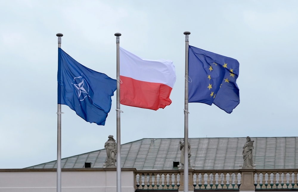 Warsaw, Poland - 14 January 2025 - Flags of NATO, the EU and Poland waving in the wind next to each other