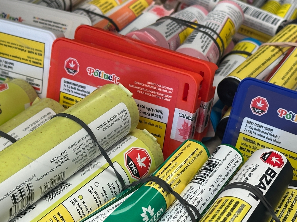 Cannabis Pre-Rolls with Warning Labels Displayed in Retail Storage Tray. Gleichen, Alberta, Canada. August 24 2025. For Editorial Use Only. This image represents the variety of legal cannabis products