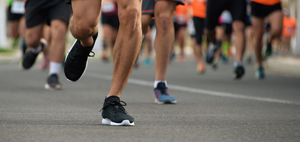 Marathon running race, people feet on city road