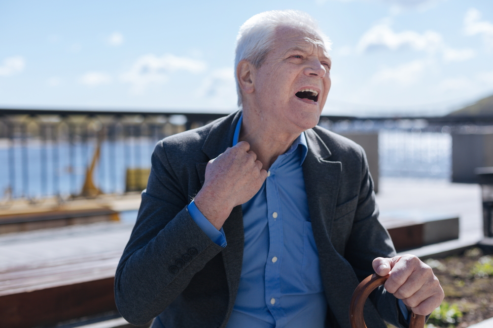 Sick man breathing hardly outdoors