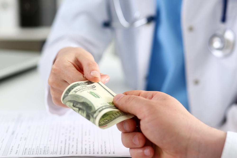 Female doctor hold in hands bunch of hundred dollars banknotes take or give them. Prestige and high paid job, encash treatment, illegal drug fraud, anonymous visitor, private visit, reform concept