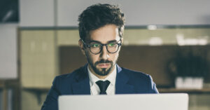 The Loyalty Tax: When Long-Term Employees Earn Less Than New Hires man using on computer