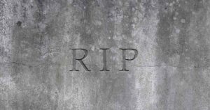 Everyone Uses 'RIP' — But Few Know Its Original Meaning Close up of RIP carved into a headstone