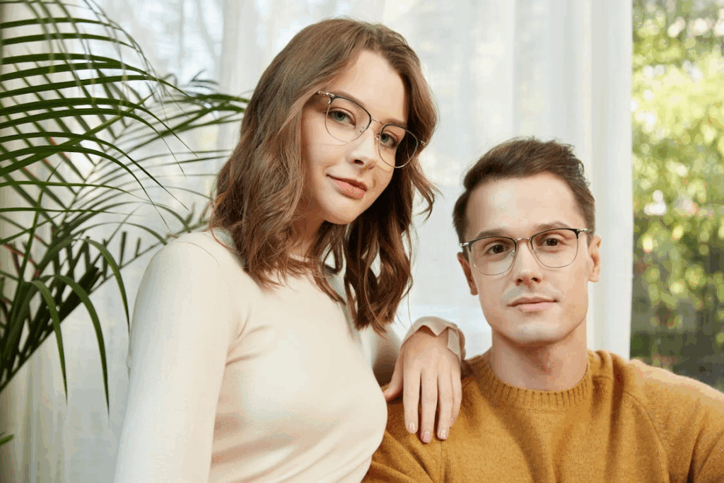 Stylish Young Couple Posing with Glasses Indoors
