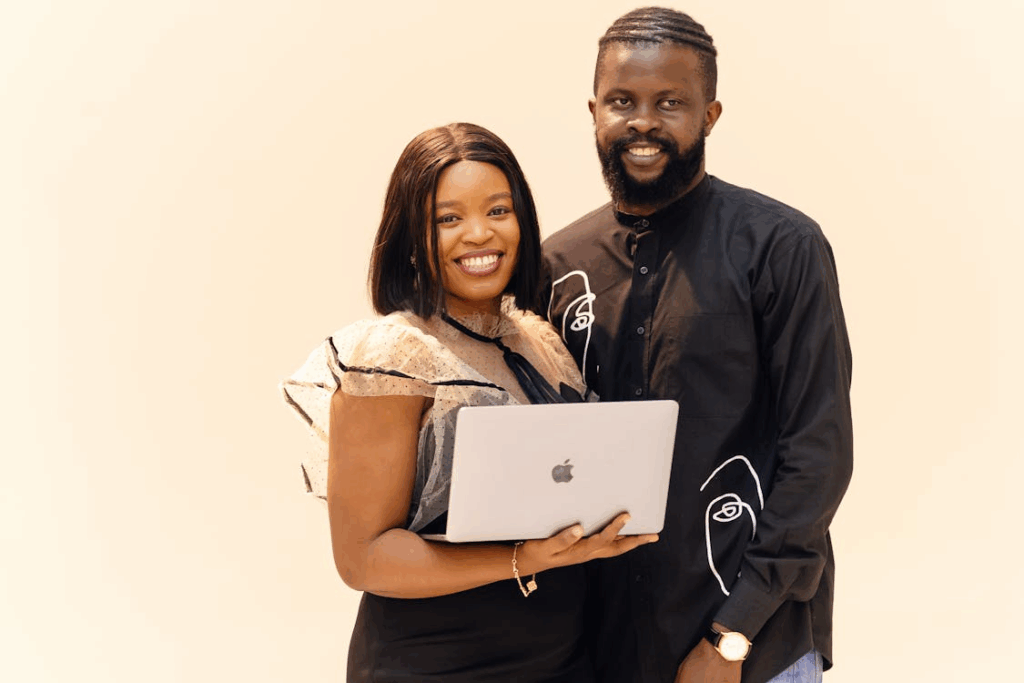 Smiling Professionals with Laptop in Lagos Office