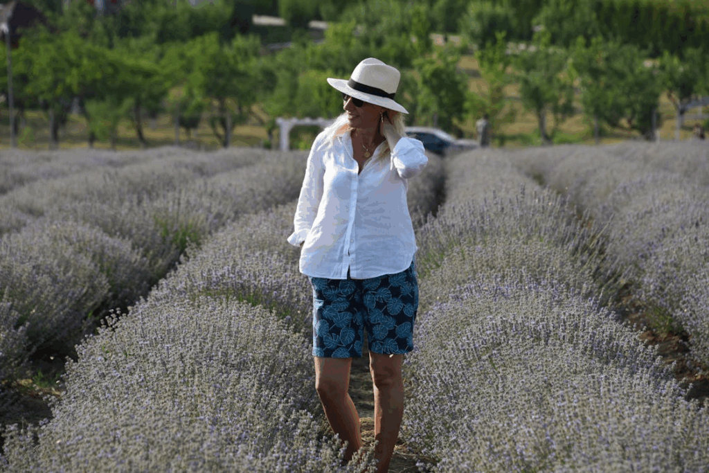 Woman Strolling Through Lavender Field on a Sunny Day