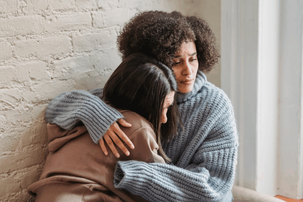 Sad women hugging at home
