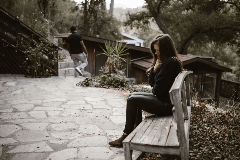 Woman Sitting alone on a Wooden Bench after a Breakup
