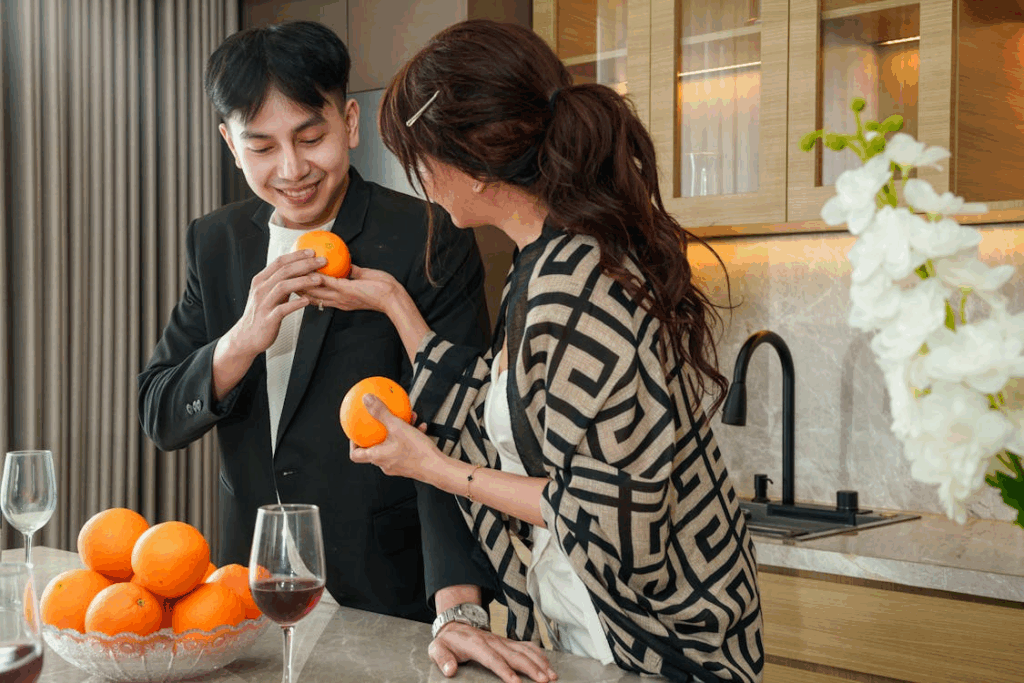 Couple Enjoying Fresh Oranges in Modern Kitchen