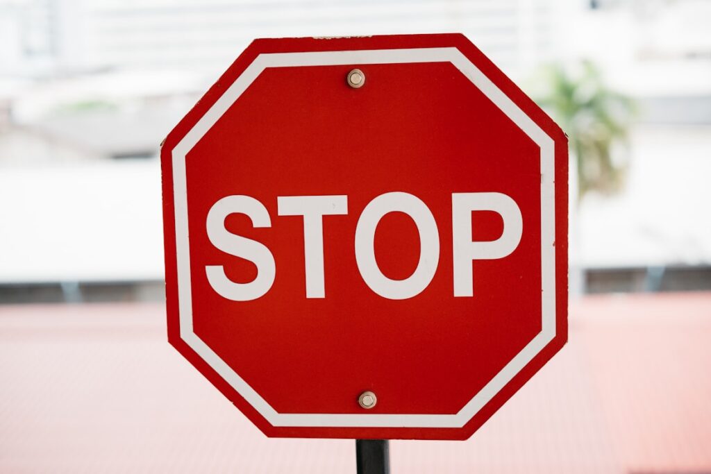A red octagonal stop sign against a blurred background.