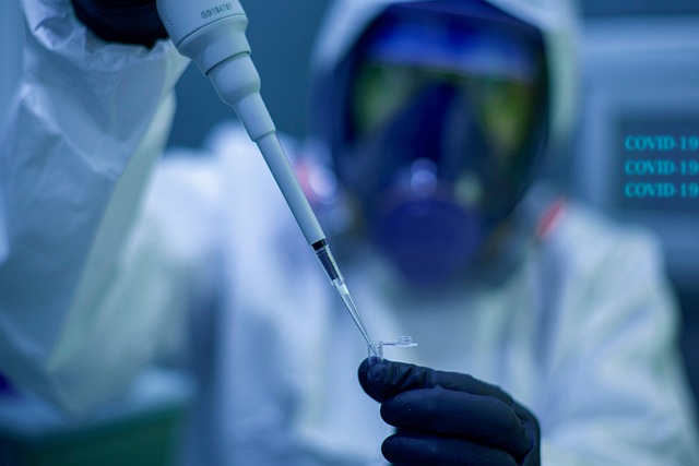 man putting vaccine into a vial