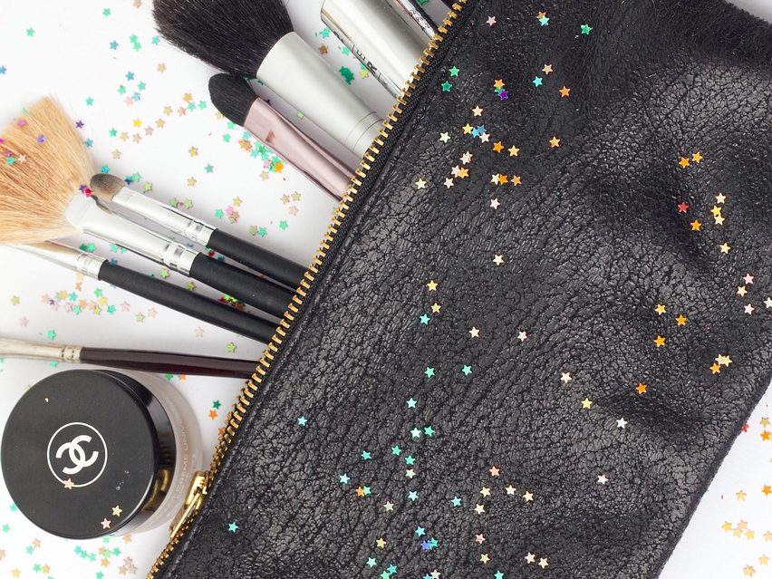 Reusable travel bag with cosmetics and star-shaped rainbow glitter.