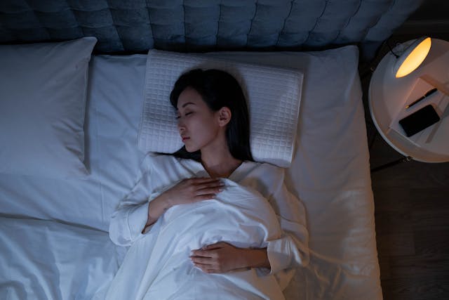 woman lying in bed asleep 