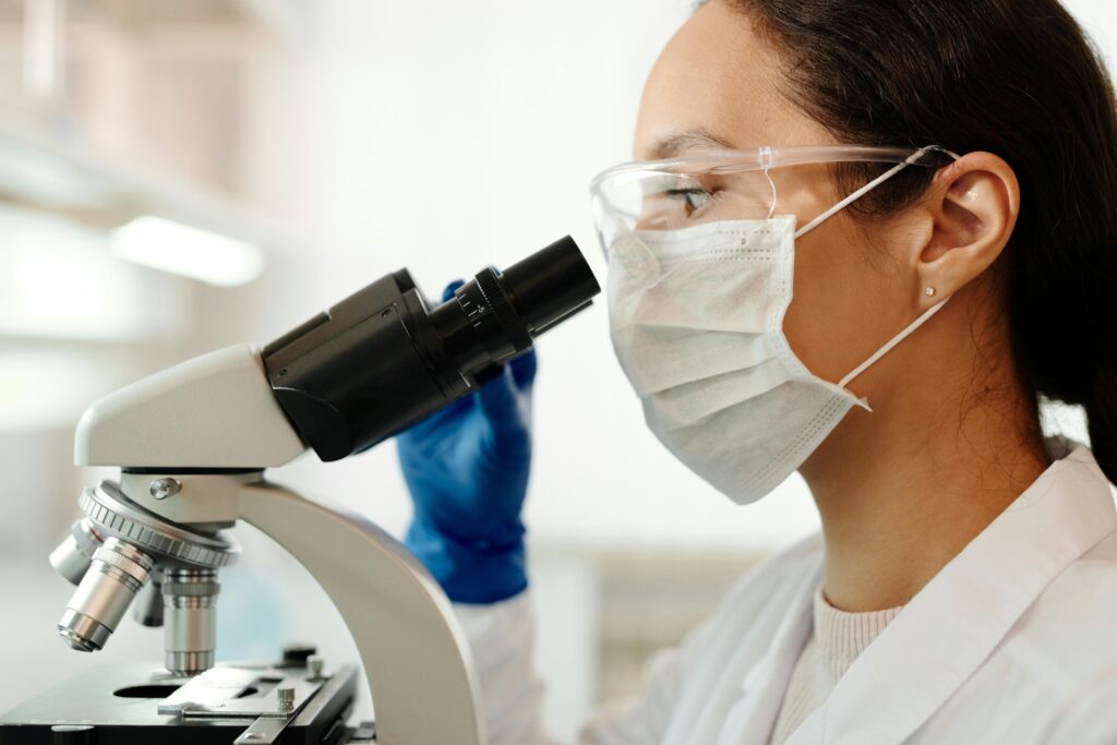 Female Laboratory Scientist Looking at a Microscope
