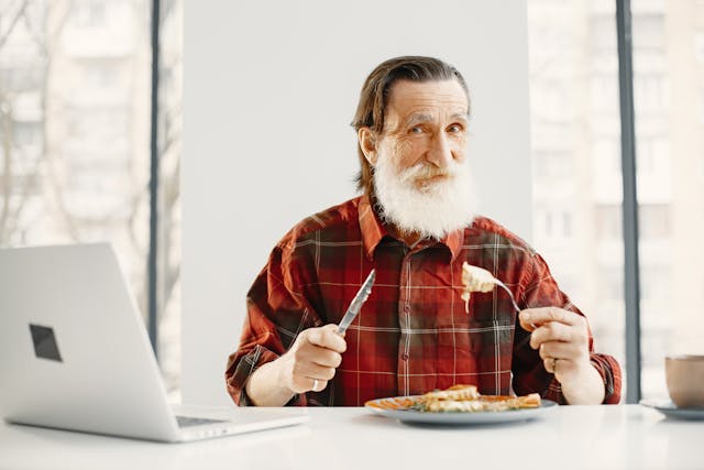 elderly man eating food