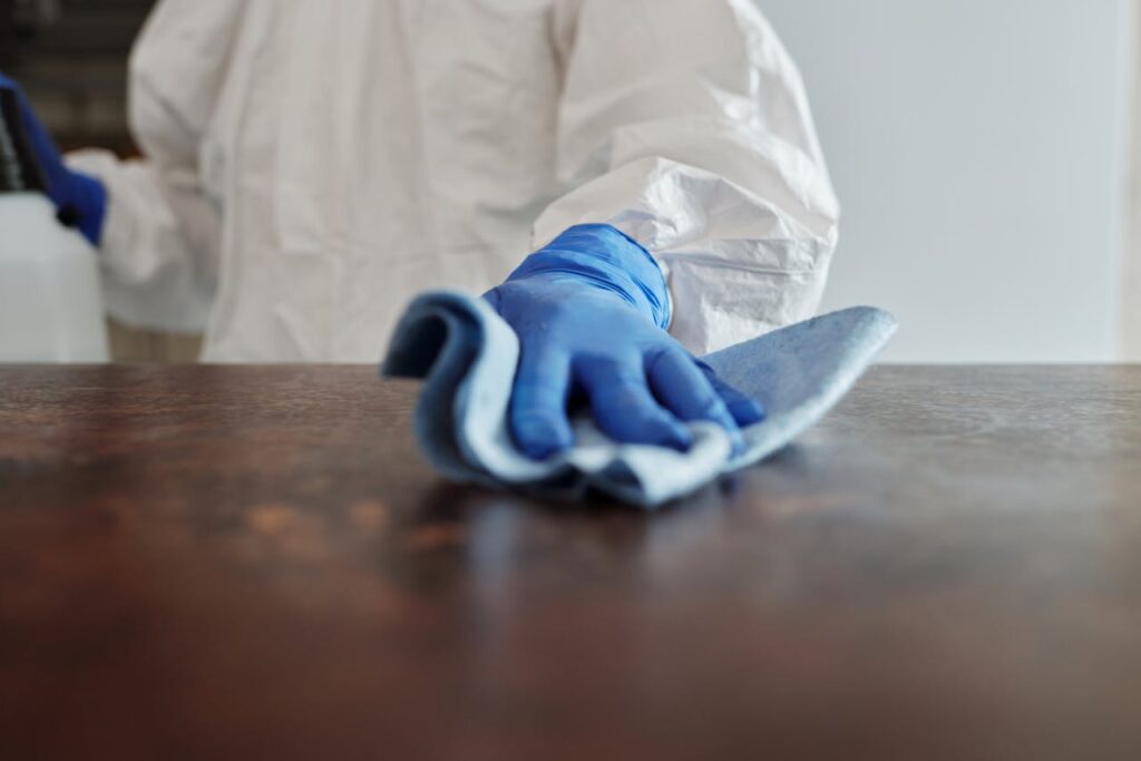 Close-Up Photo Of Person Cleaning The Table
