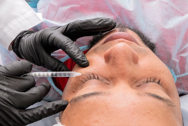 Surgeon injecting under eye