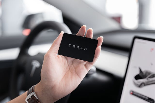 hand holding a TESLA card