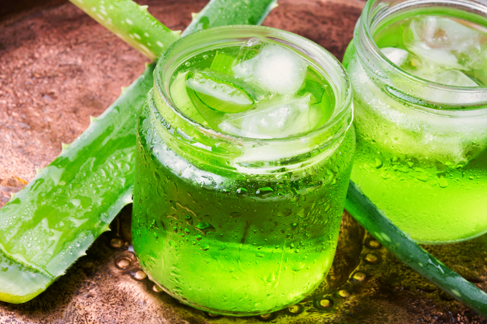 fresh sliced aloe vera leaves and aloe vera juice