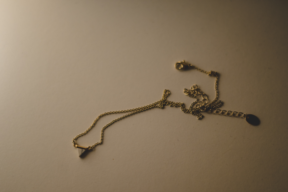 Tangled necklace beige background