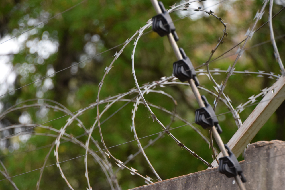 Barbed wire and electric fence wall security