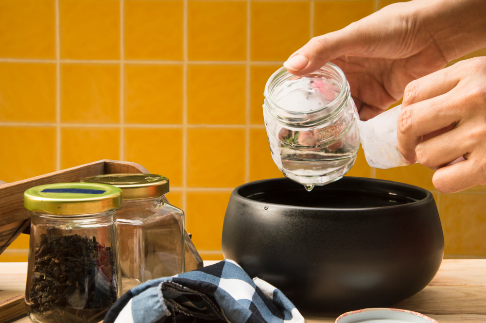 after soak glass jars in boiling water,  leave it's cool until you can handle, easily peel label without leave bits of paper and glue residue