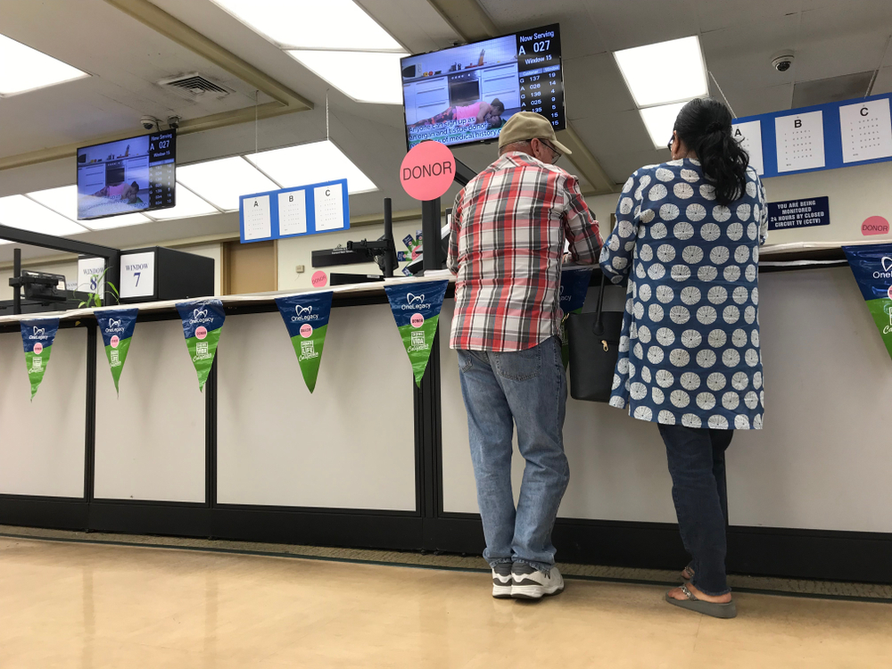 Los Angeles, April 25, 2019: DMV Department of Motor Vehicles. Close up of a couple standing at a counter at a DMV field office.