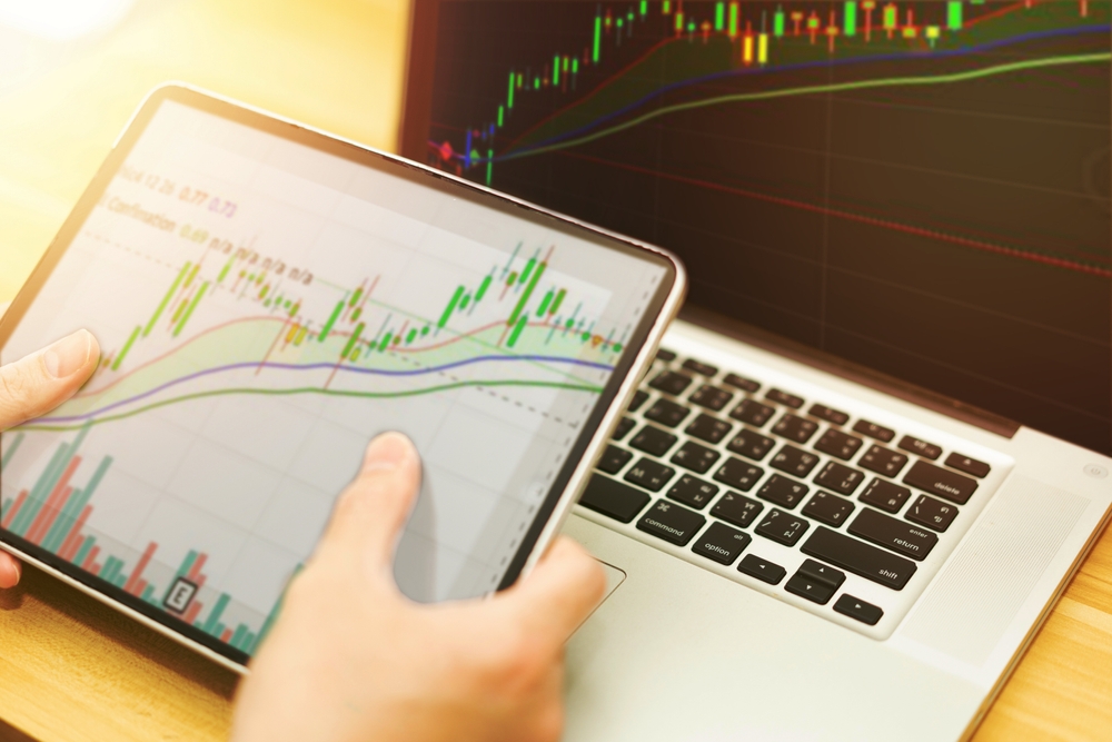 graph in computer and mobile show finance business and stock market volatility