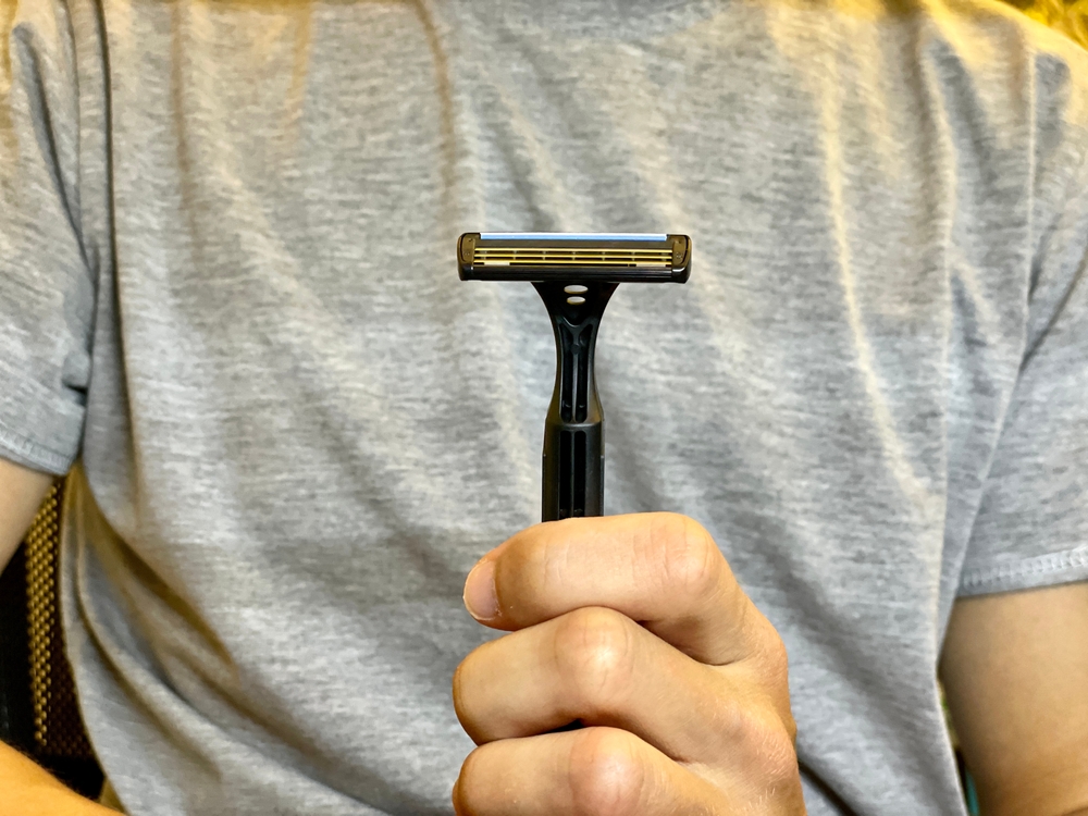 Machine for shaving. man shaving his beard with razor.man with beard and comb