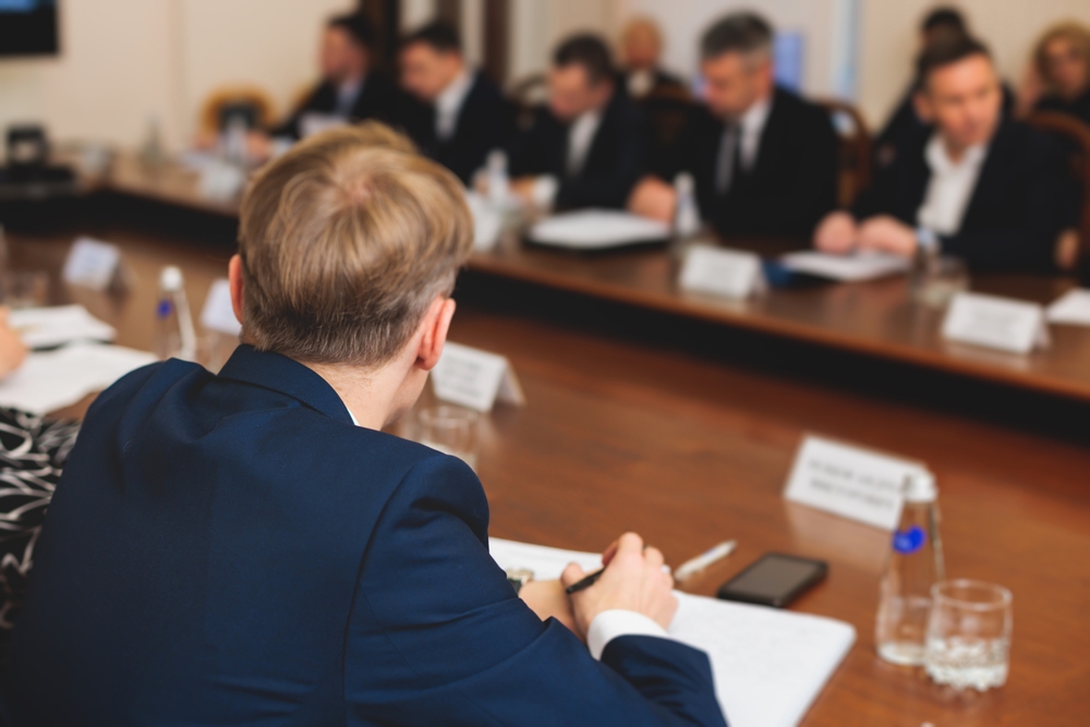 Group of men in business suits talking and discussing at conference, politicians and entrepreneurs debate, networking and negotiate, businessmen have dialog conversation on a forum, panel discussion