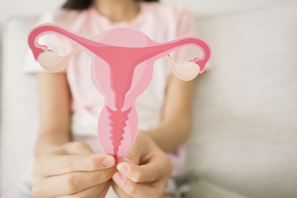 Preteen girl hands holding uterus, teen health, PCOS, first period concept